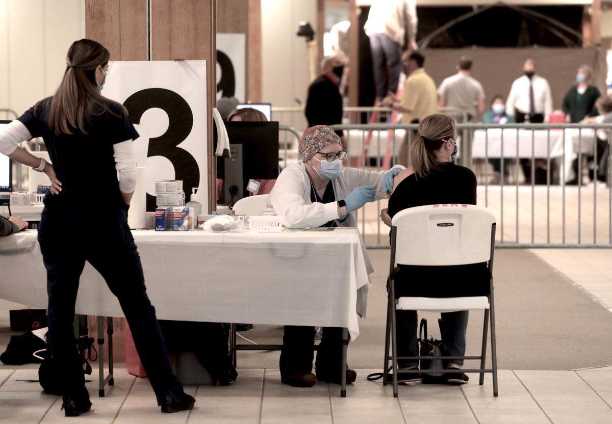 Volunteers administer a coronavirus vaccine at Rock Hill’s vaccination clinic. South Carolina health officials are not requiring vaccine seekers to prove residency.