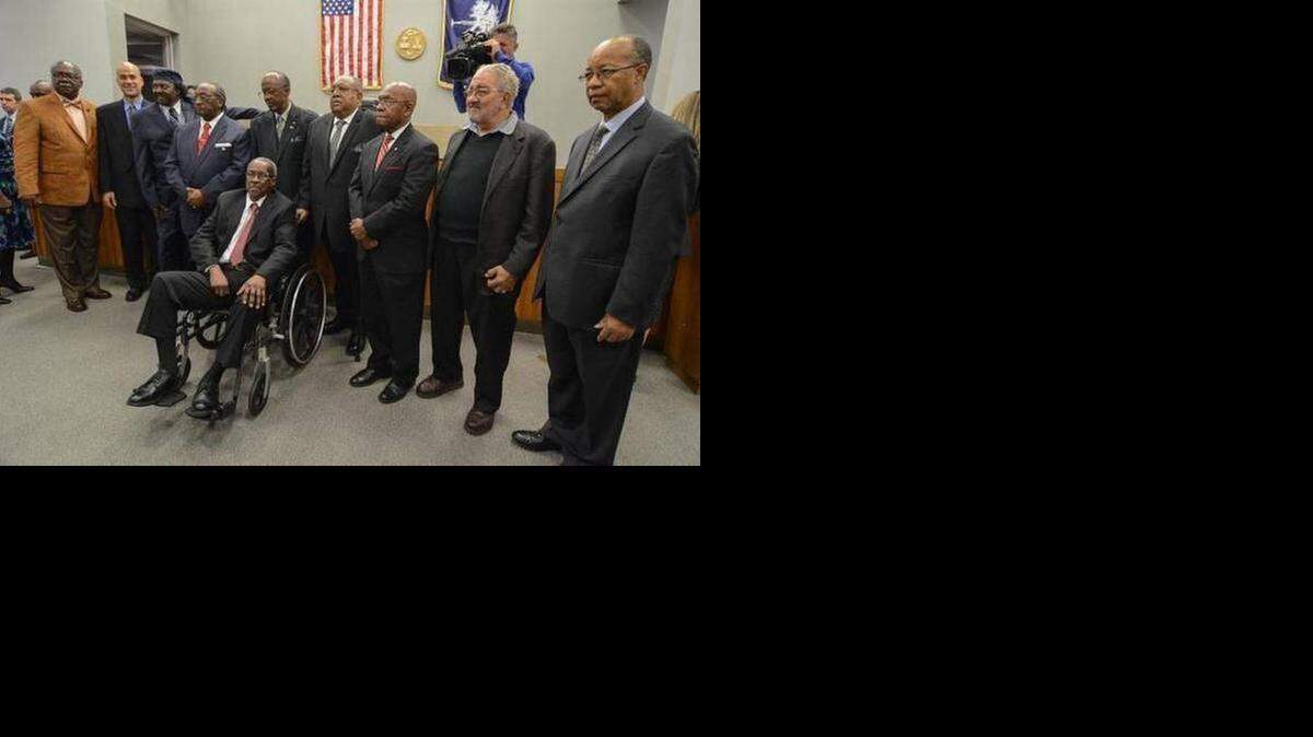 
The surviving members of the Friendship Nine and other civil rights protesters whose 1961 convictions for trespassing were vacated in January by a judge. From left, David Williamson, Kenn Gaither (standing in for his father, Thomas Gaither), Mack Workman, Willie McCleod, John Gaines, Clarence Graham, W.T. Massey, Charles Jones, Charles Sherrod and James Wells (seated). 
