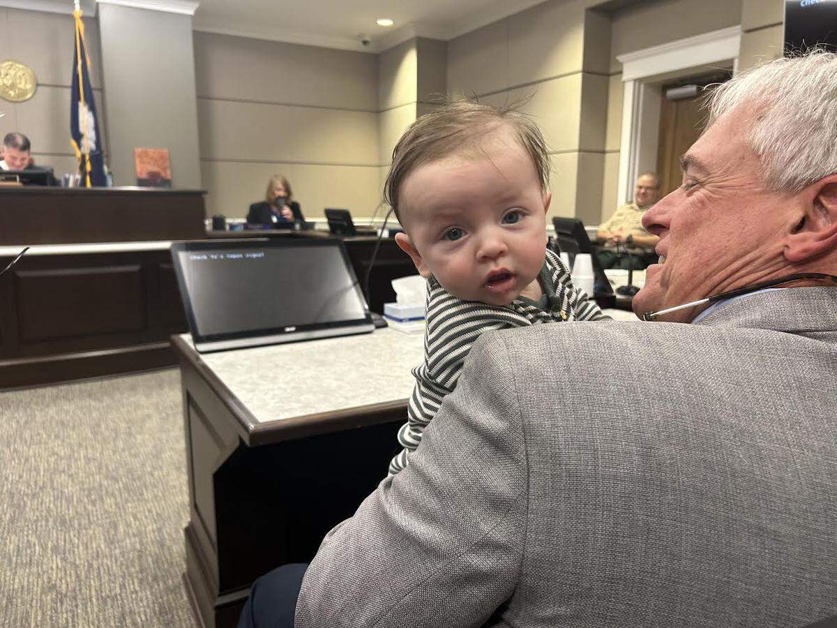 Baby Jude Anderson, held by father Jeffrey Anderson, during Jude’s adoption on Dec. 23, 2025, in York County Family Court.
