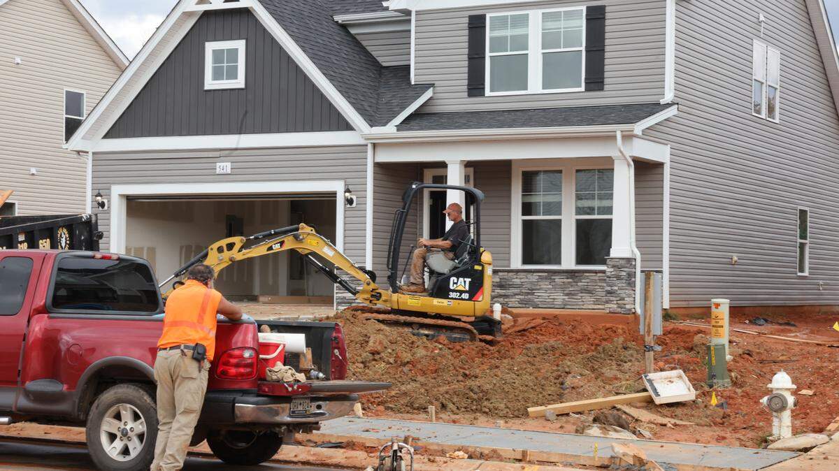A crew works on a yard of a newly-built home Wednesday in the Bailey’s Run subdivision in York County.