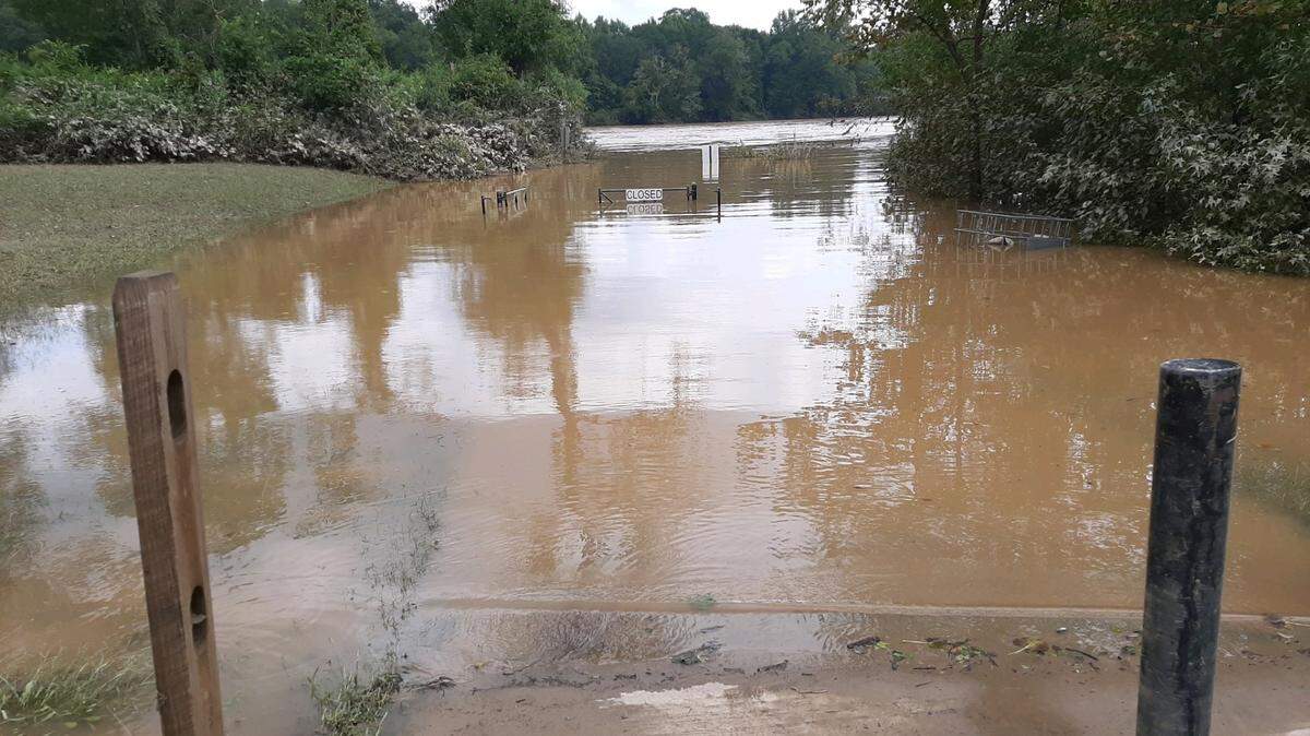 The Catawba River continued to run high, fast and brown on Monday afternoon due to water flowing from Helene.