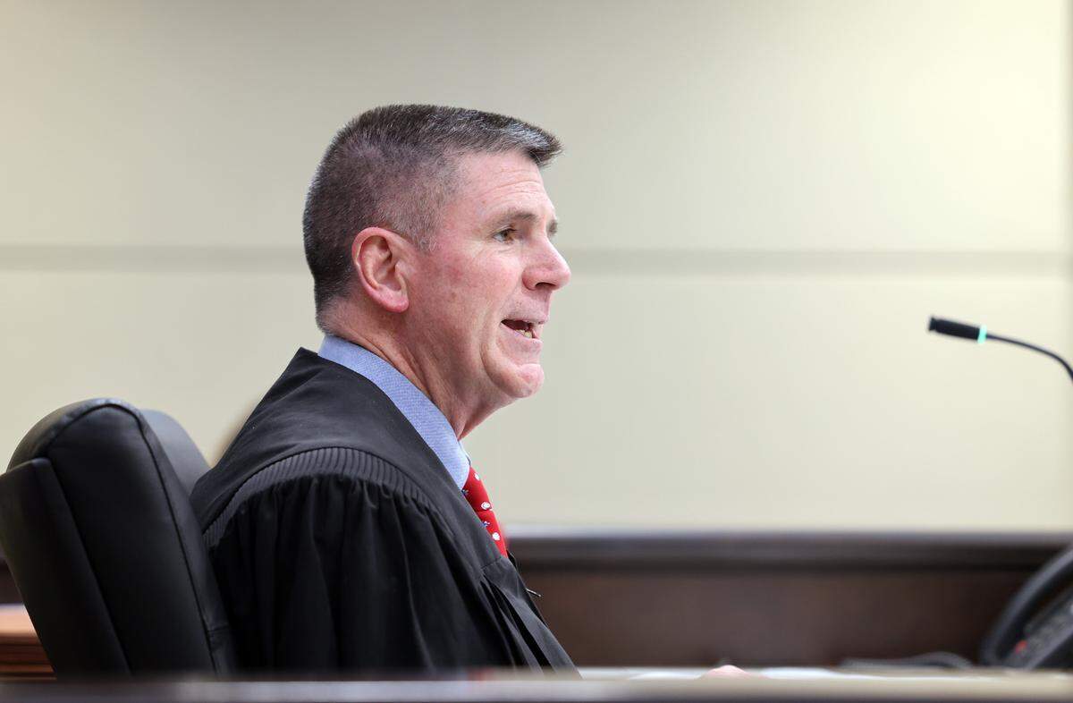 York County Family Court Judge David Guyton talks to John and Kendal Farmer during an adoption hearing Wednesday where the couple adopted a 2-year-old boy.