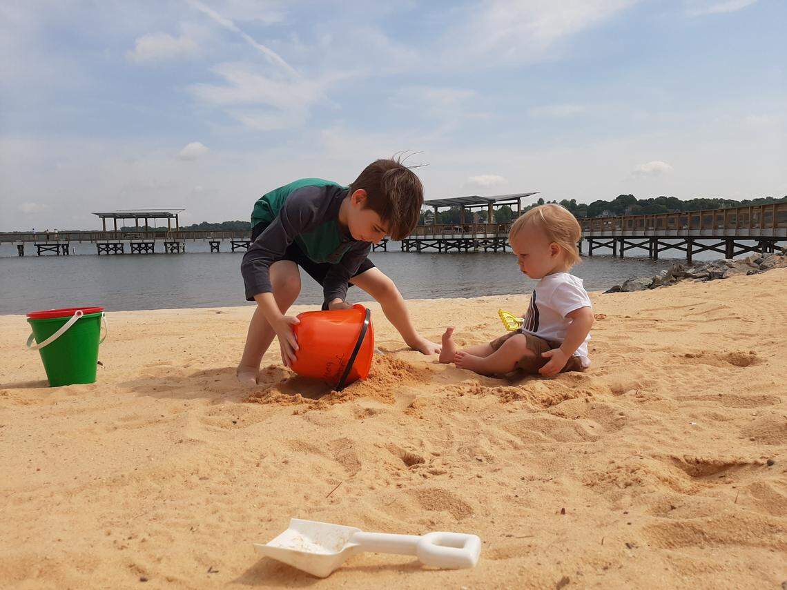Jameson Bowman, 8, and John Bannon, 1, play at the newly redone swim beach at Ebenezer Park in Rock Hill, in this 2021 file photo.