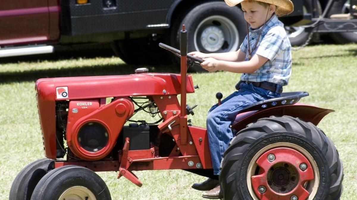 Ethan Muggleston rides a child-sized tractor at last year’s McConnells Antique Tractor and Engine Show.