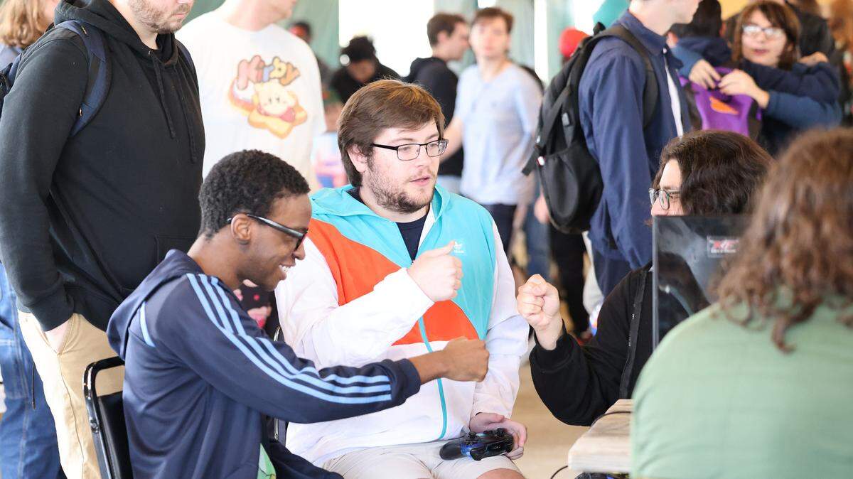 Gamers at the Rock the Winds esports tournament fist bump after winning a game Saturday at Carowinds.