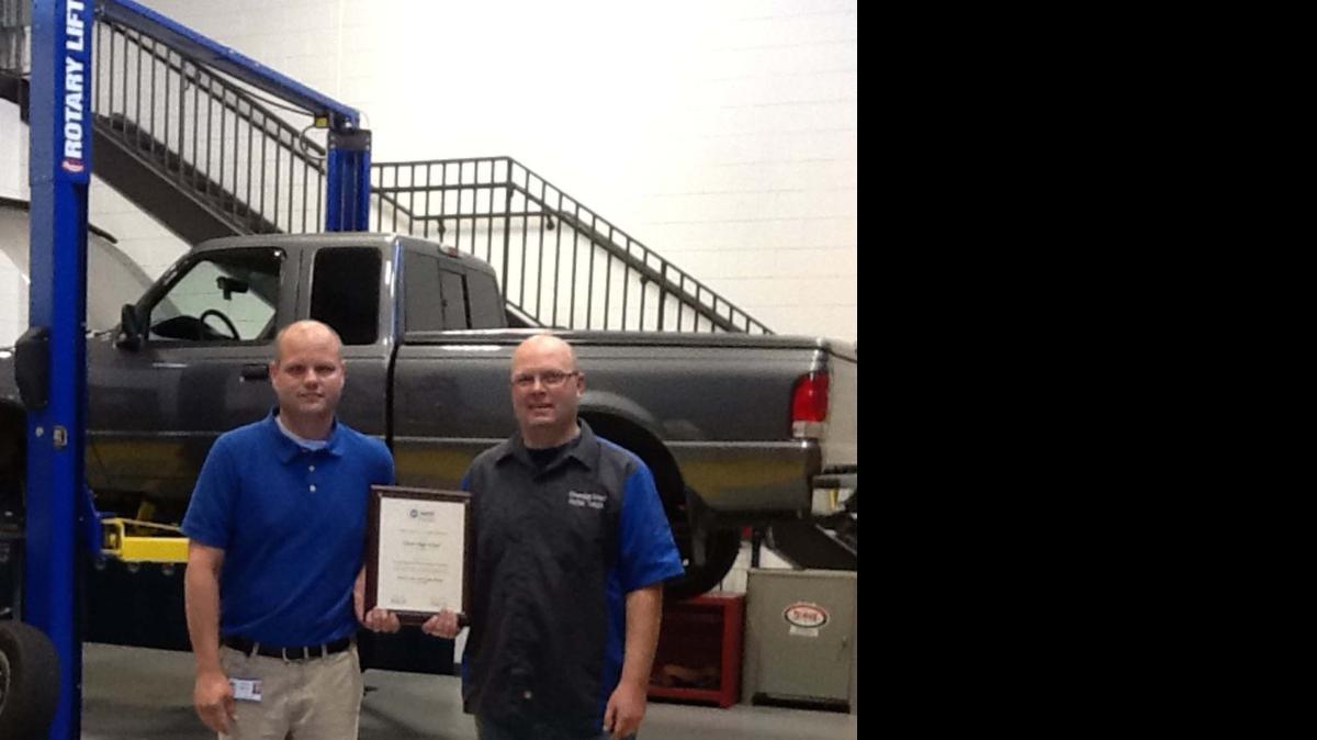 
Clover High School Automotive Technology instructors Jeff Sigmon, left, and Jason Currence hold the plaque showing the program earned the Maintenance & Light Repair accreditation from the National Automotive Technician Educators Foundation Inc. 
