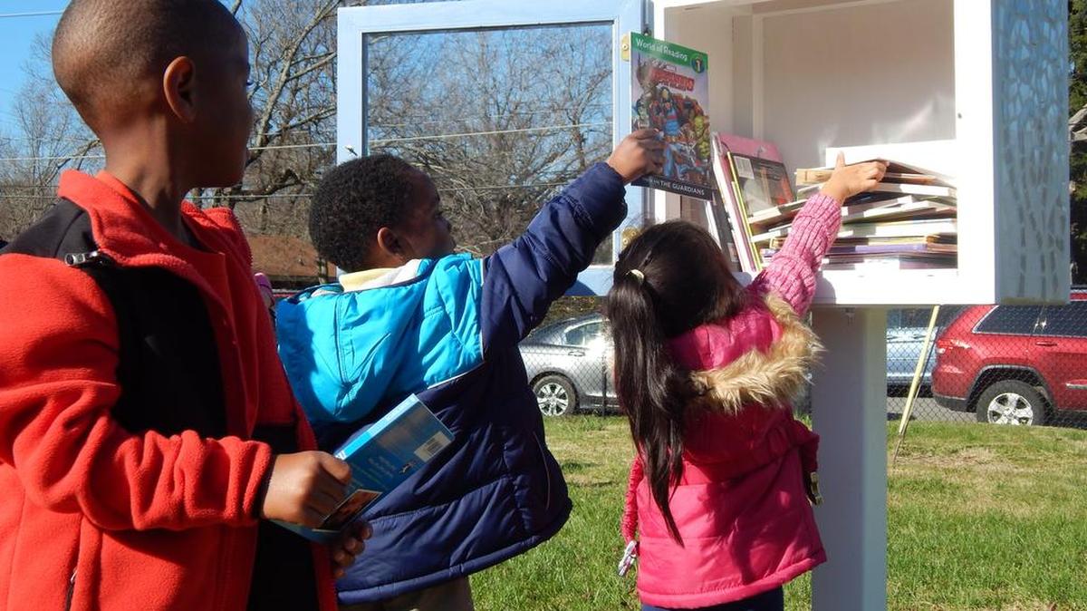 Children from the Head Start program at the York Parenting Partnerships Resource Center fill a Little Free Library dedicated last week.
