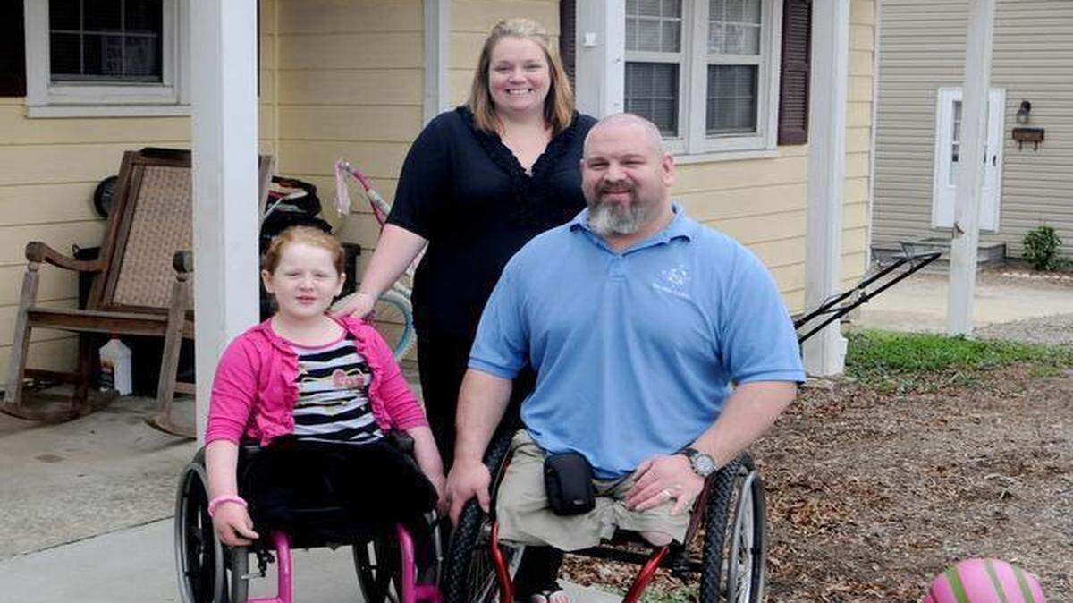 
Matt and Renee Aldridge, with their daughter, 7-year-old Madeline, have been engaged in a disagreement with the Clover school district over issues surrounding her wheelchair access and school bus transportation. Matt and Madeline have had both legs amputated due to a genetic disability that also affects two of the Aldridge’s younger children.
