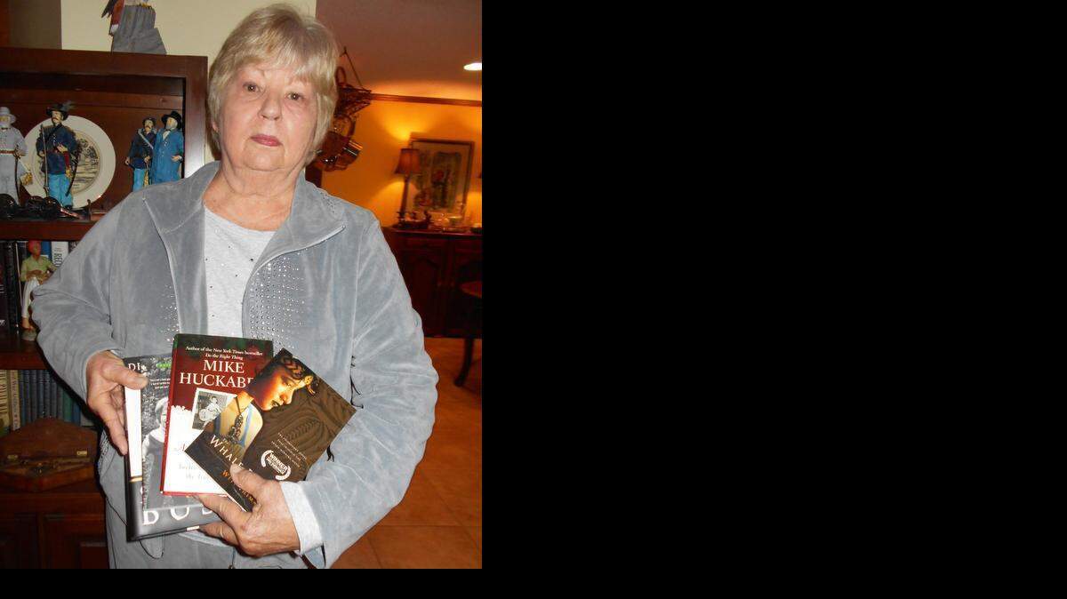 
Clover-Lake Wylie Republican Women’s Club member Carol Blackwell holds the four books the club donated to the Clover High School library. 
