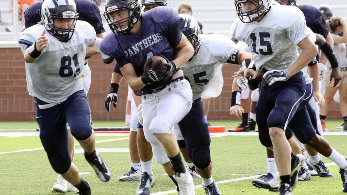 
Chapman’s Daniel Pruett carries the ball as Clover’s Peyton Signs (81) runs by.
