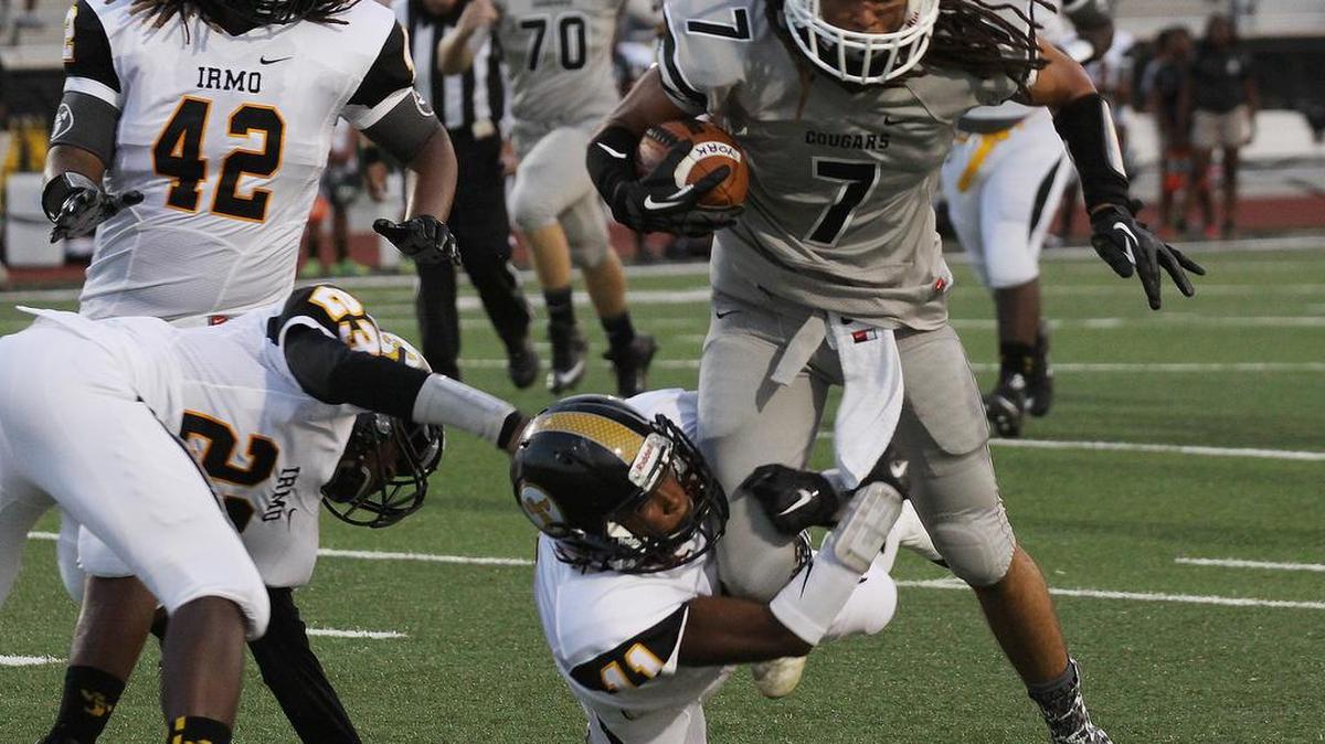 
York’s Wally Wilmore tries to escape from Irmo defenders on Friday in York.
