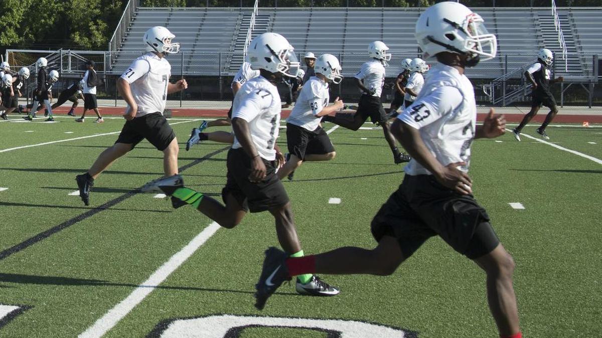 
The York Comprehensive High School football team dashes to the 30 to warm up during practice.
