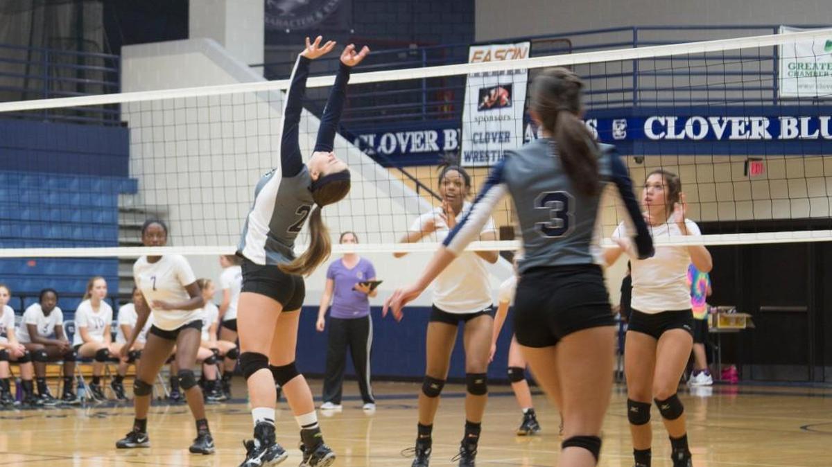 
Clover’s Savannah Garrigan, left, sets the ball up for team mate Brooklyn Thomas to spike during a match against Northwestern.

