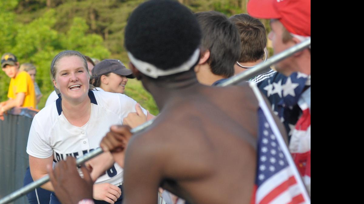 
Fans congratulate Clover pitcher Elizabeth Edmunds on Friday after Clover defeated Northwestern 2-1, securing its spot in the 4A state title series.
