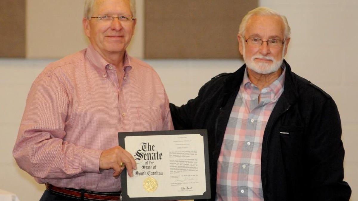 State Rep. Dennis Moss, R-Gaffney, left, presents a proclamation from the state to Jerry West for his leadership in the Museum of Western York County.