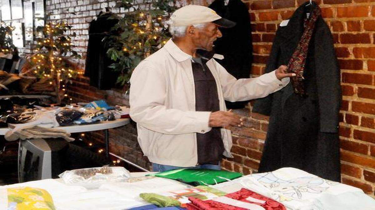 
Bobby Johnson, a member of the Roosevelt Community Watch in Clover, checks out merchandise on sale during a fundraiser for the Stellie Jackson enrichment center at Roosevelt Park.
