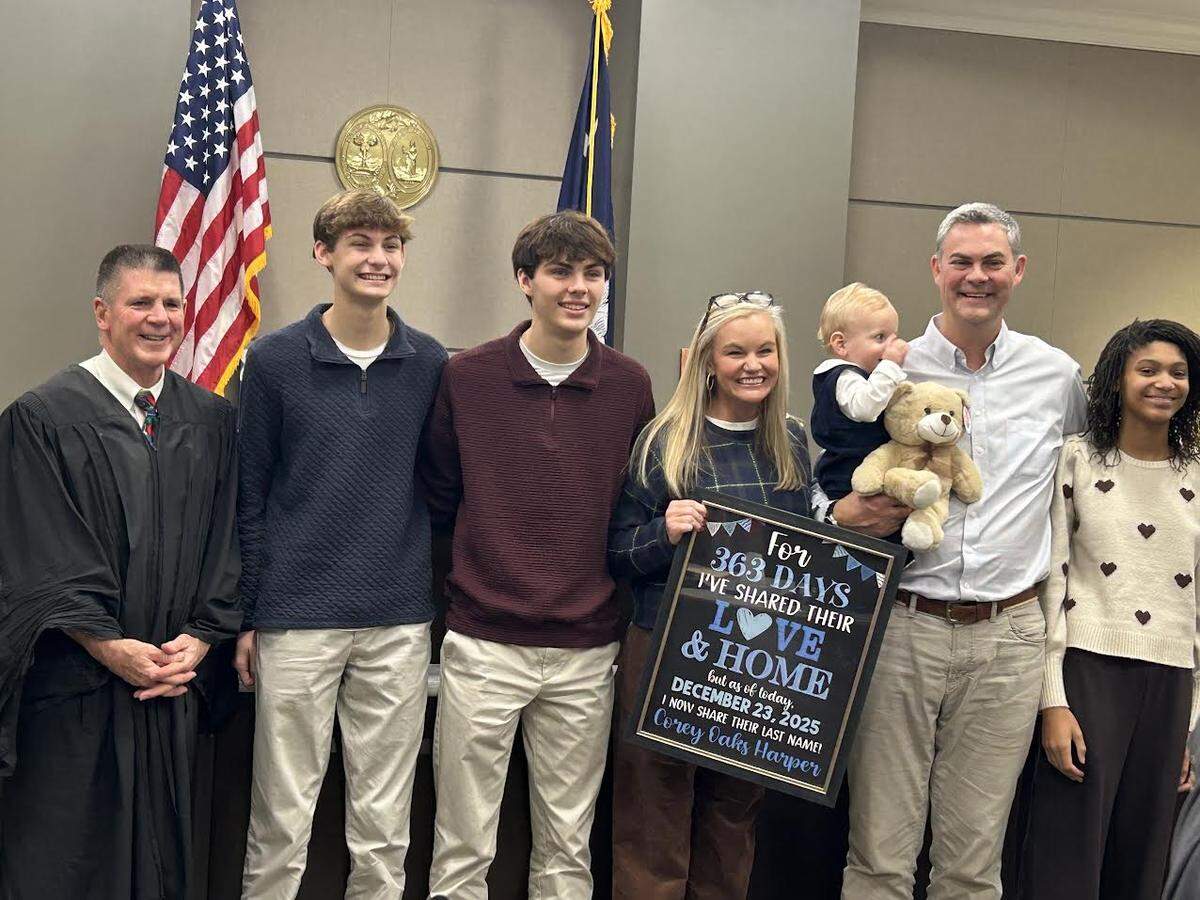 York County Family Court Judge David Guyton, left, with the Harper family after baby Corey was adopted on Dec. 23, 2025.