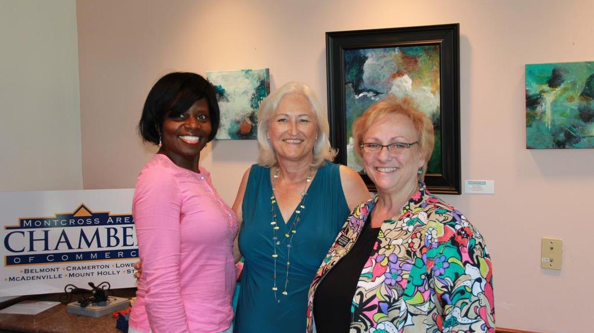 
Artist Marcee Musgrove, center, celebrates the opening of her exhibit “Bridges” in Belmont with Gaston Arts Council Executive Director Kim George, left, and Montcross Area Chamber Board Chairwoman Melia Lyerly. 
