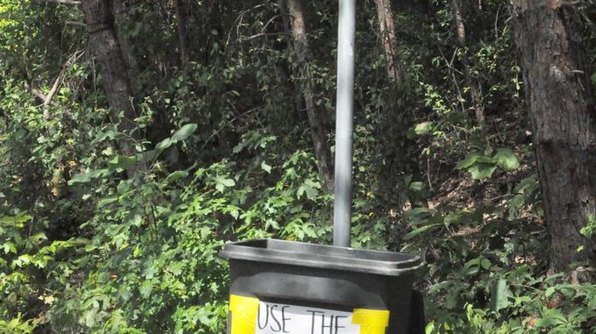 
Danielle and Jay Schoolmeesters set up a garbage can under the No Littering sign on Rufus Ratchford Road in Lake Wylie.
