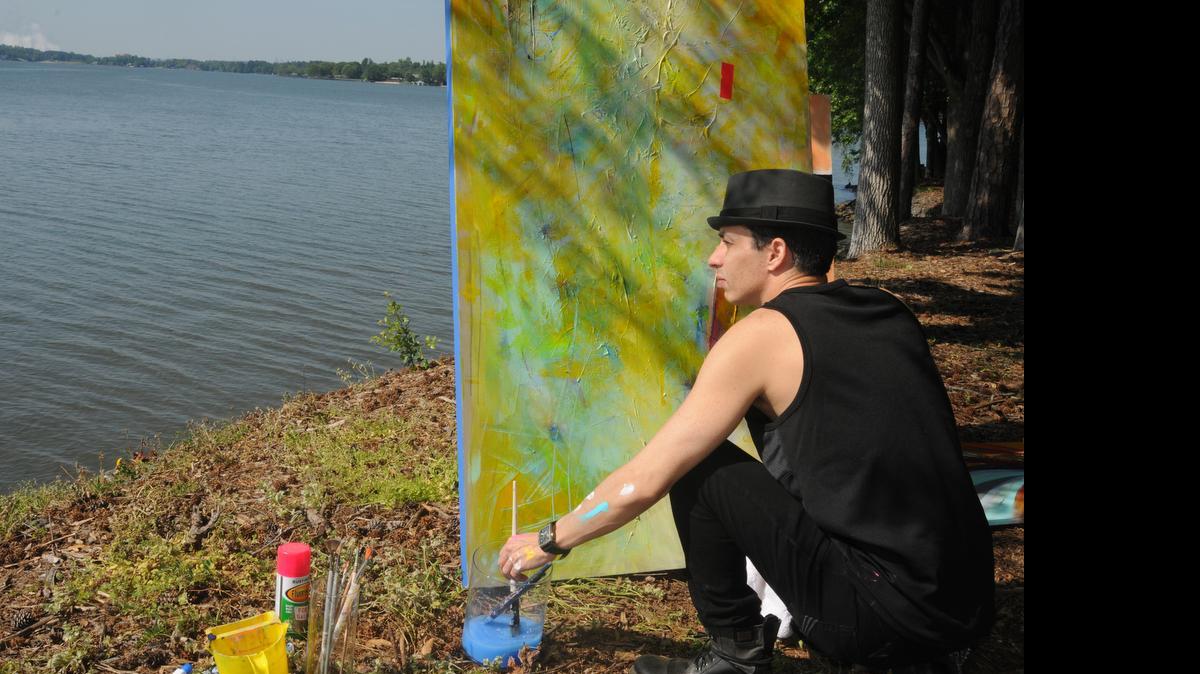 
Jonay di Ragno paints at a point near his River Hills home in Lake Wylie. The artist is working to bring gallery events to Lake Wylie, beginning with Art Night on May 20 at The River Rat restaurant.
