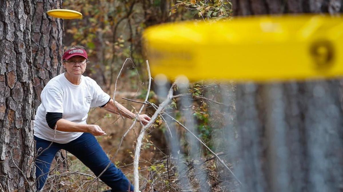 
Christene Wright putts at the ninth on a disc golf course in Chester. Tega Cay just opened its own course.
