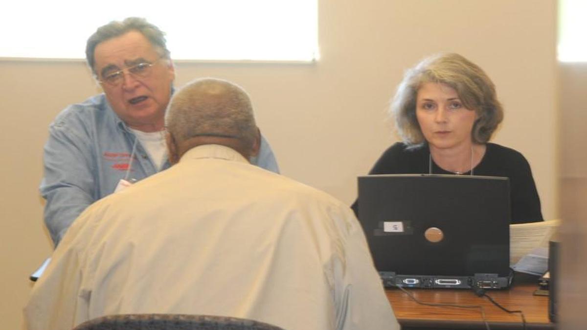 AARP Tax Aide volunteers prepare a tax return for a client at the Fort Mill Library.