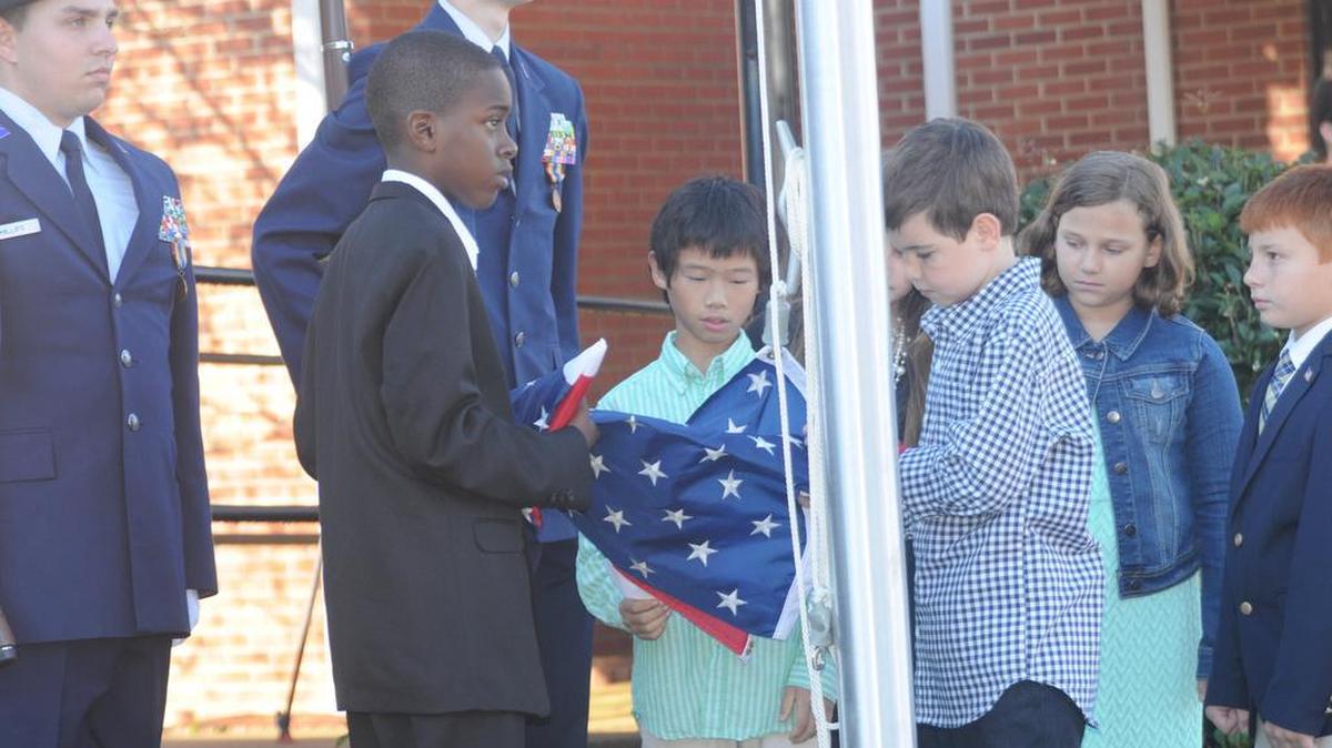 Students raise the flag Nov. 10 during a flag pole dedication ceremony at Pine Grove Christian Academy in Lake Wylie.