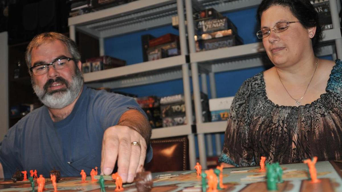 Mark and Gina Kale set up the board for a game of Empires: Age of Discovery. The Fort Mill couple are hosting MegaMooseCon in Richburg, a large gathering for board game enthusiasts from the Charlotte and Columbia areas.