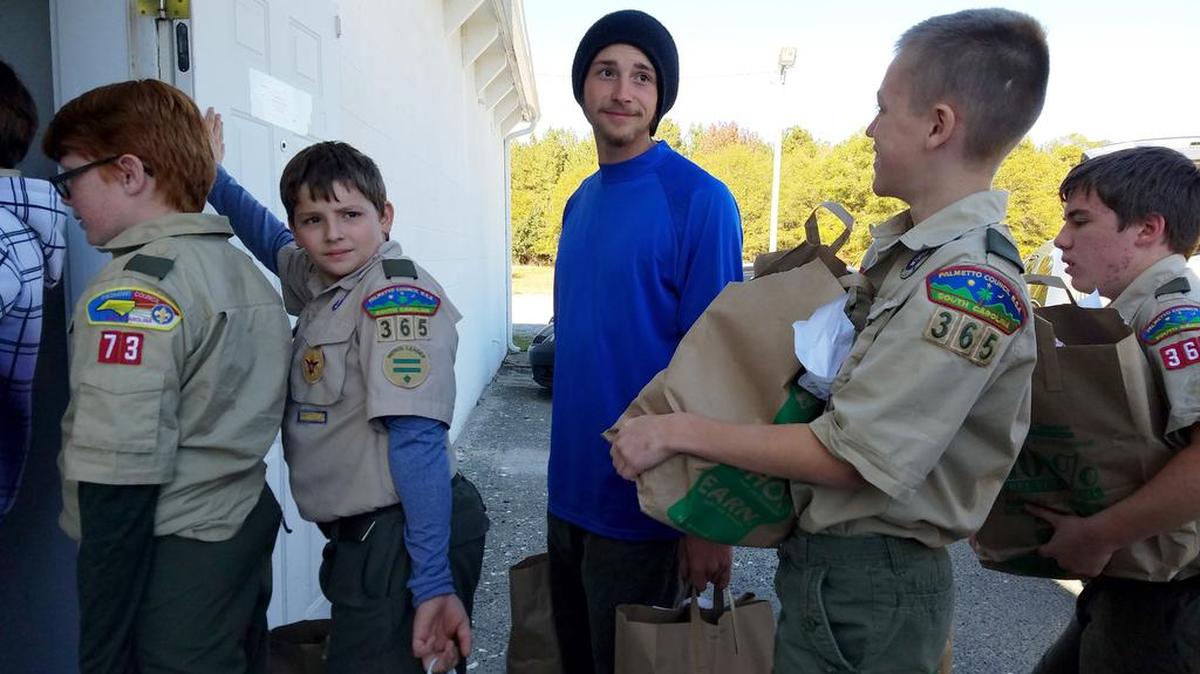Eagle Scout Greyson Floyd, assists Boy Scouts from Troop 365 All Saints, unloading food donations at Clover Area Assistance Center during Scouting for Food in November. Troop 365 brought in the largest single donation of 4,071 pounds. Greyson earned his Eagle Scout award in 2015 by renovating CAAC's lobby.