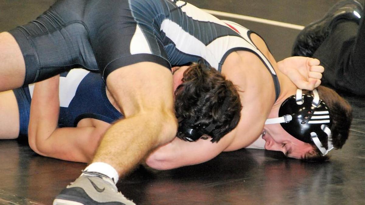 Nation Ford’s T.J. Giarratana goes for a pin against Clover to give the Falcons a win over their region opponent.