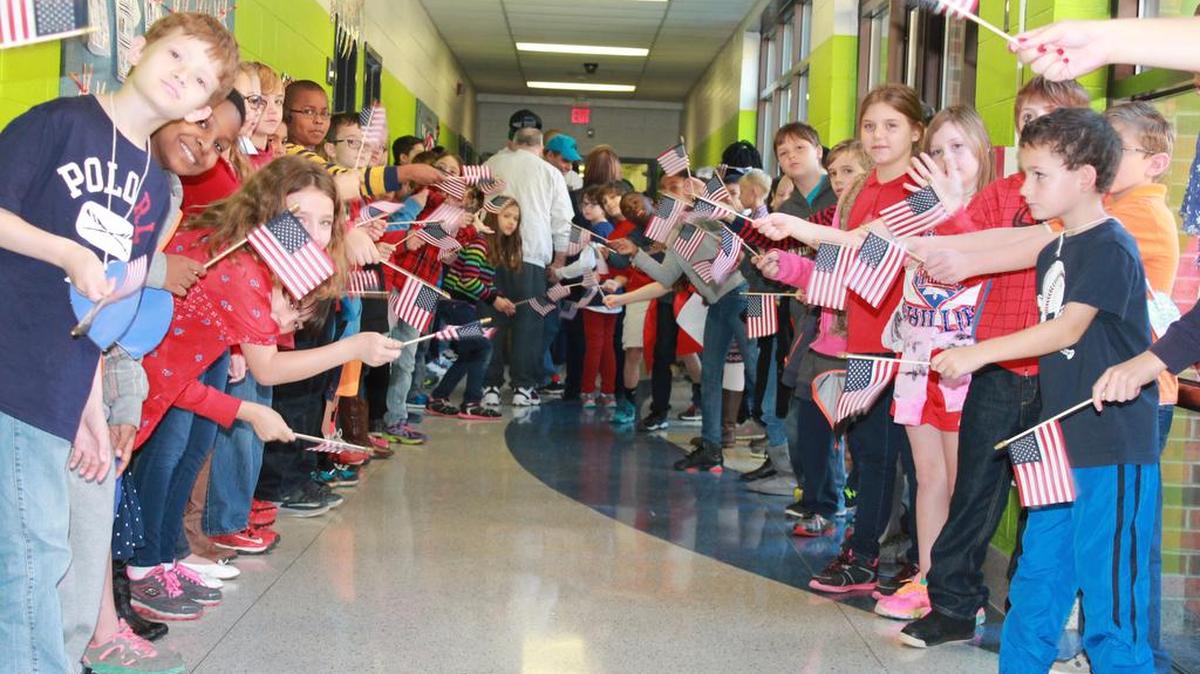 Bethel Elementary School students lined the hallways waving flags donated by 40 & 8 while the veterans walked out of the multipurpose room following a Veterans Day assembly.