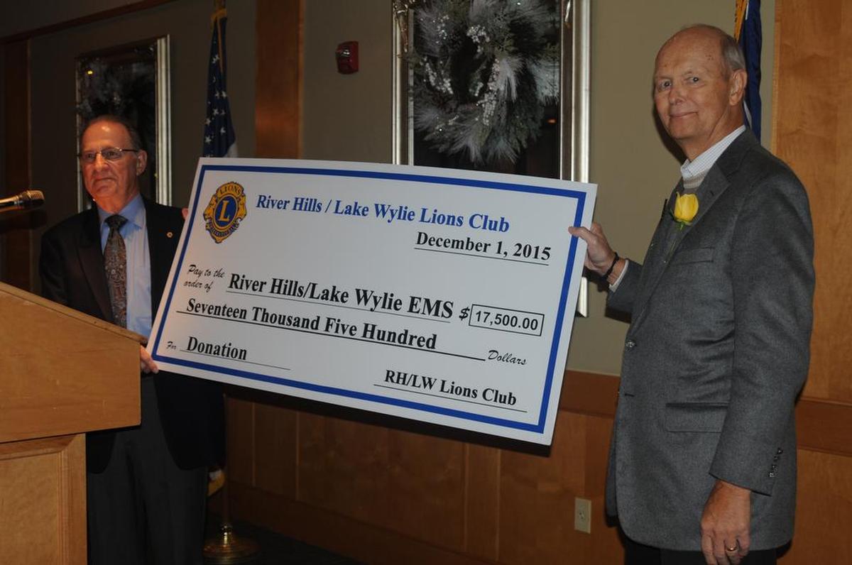 River Hills/Lake Wylie Lions Club president Len Fleet presents a check for $17,500 to Bruce Roberts of River Hills/Lake Wylie EMS at River Hills Country Club in this 2015 file photo. The ambulance service began with seed money from the Lions Club and relied on donations for many years.