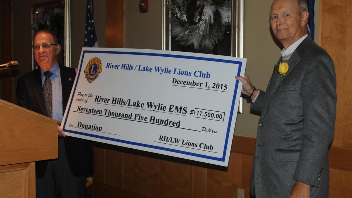 River Hills/Lake Wylie Lions Club president Len Fleet presents a check for $17,500 to Bruce Roberts of River Hills/Lake Wylie EMS at River Hills Country Club in this 2015 file photo. The ambulance service began with seed money from the Lions Club and relied on donations for many years.