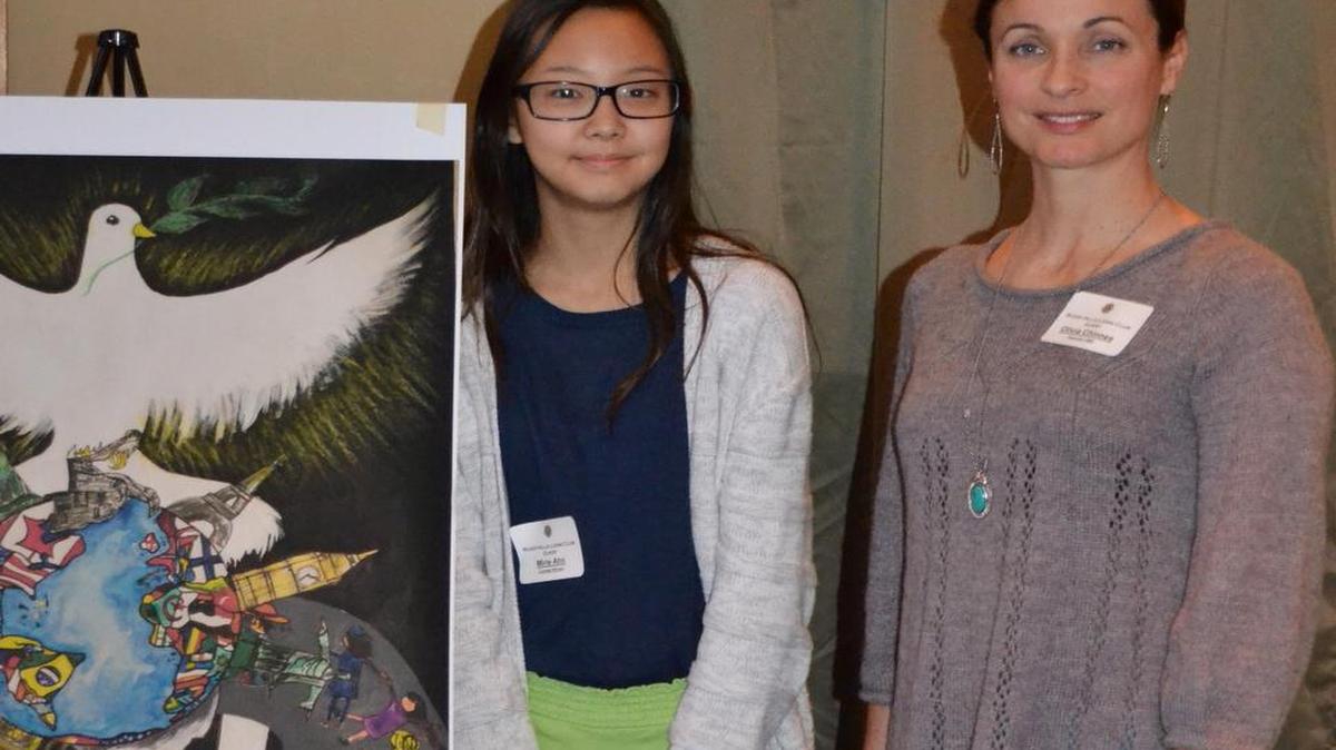 Oakridge Middle School art teacher Olivia Chinnes, right, with student Mirie Ahn, a multi-level winner of the International Lions Peace Poster contest.