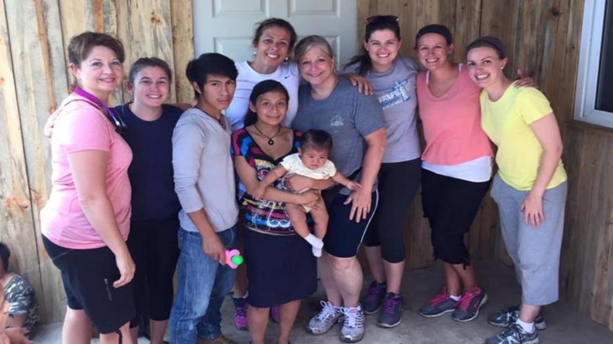 
Seven educators from Sugar Creek Elementary pose in front of the home they built for a Guatemalan family during a Give and Teach Mission Trip this past summer. Pictured with the family, from left, are: Lisa Hudson-Lucas, Caitlin Bachman, Michelle Gritz, Carol Claypool, Kendra Green, Megan McNinch and Erin Watson.
