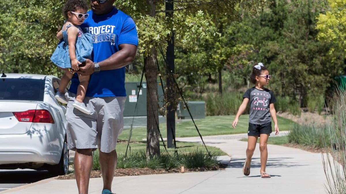 Maurice Murphy walks down the sidewalk in Kingsley with his daughters Madalyn and Makenlee Sunday. Fort Mill Town Council is tackling the issue of walkability