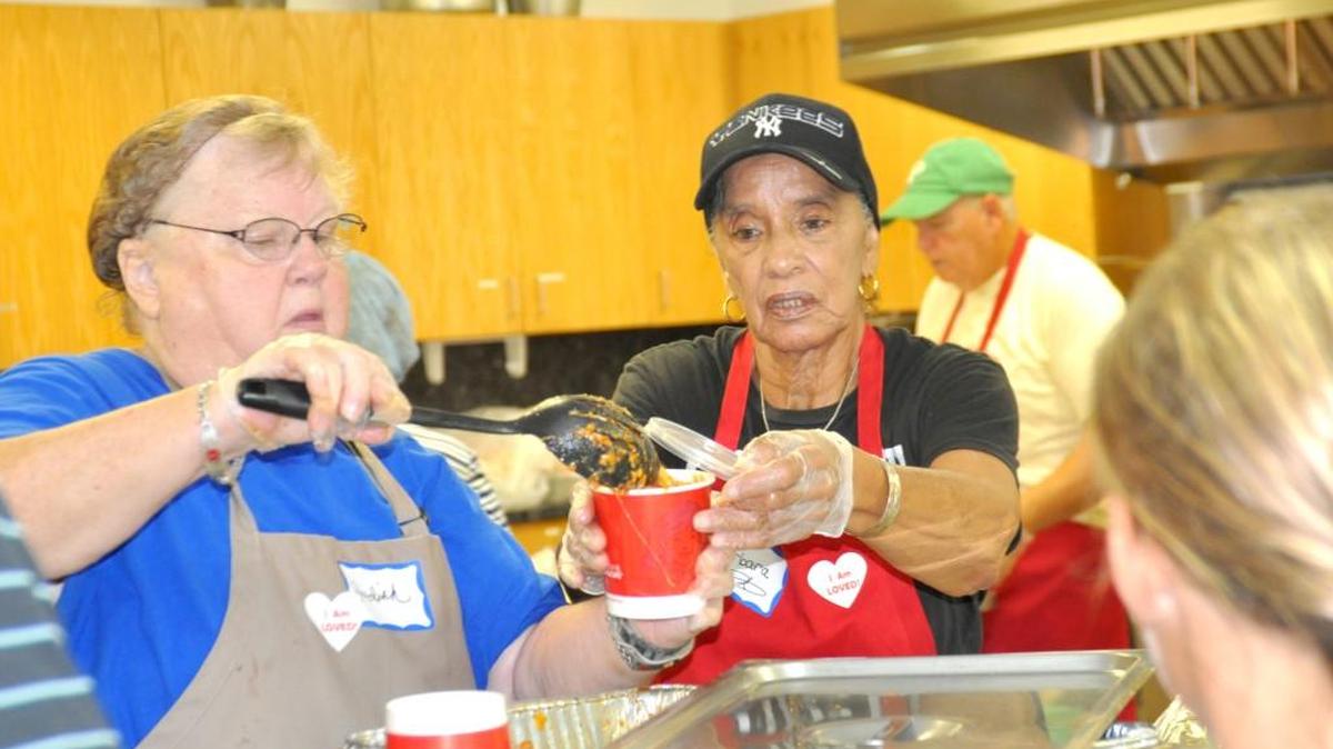 Cafe Volunteers Judith Guidebeck, left, and Barbara Wherry serve lunch Aug. 9 at the Lake Wylie cafe.