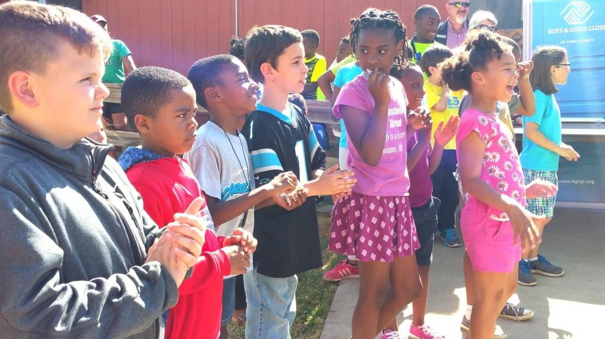 Local children celebrate the opening of a new Boys & Girls Club art program at the Springfield Elementary School facility in Fort Mill last week.