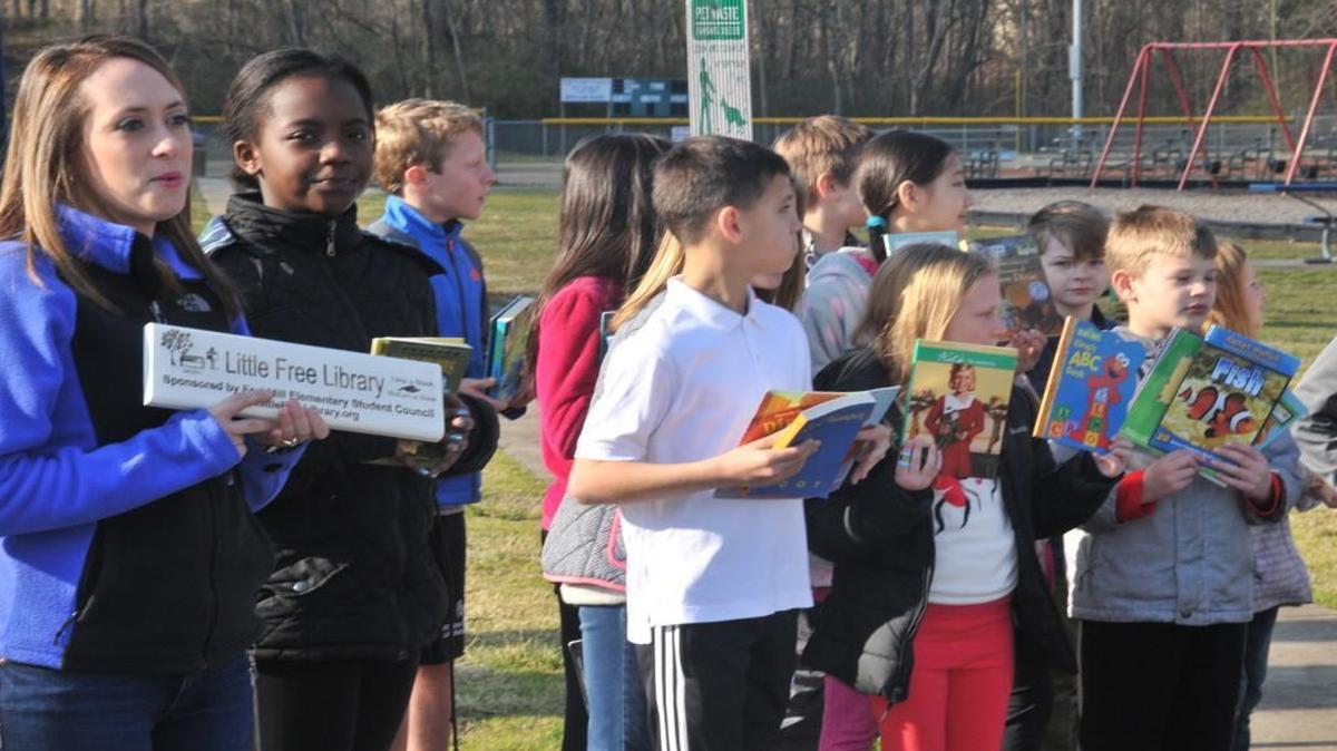 Student council members at Fort Mill Elementary School celebrate a ribbon cutting Friday for the Little Free Library at Harris Street Park.