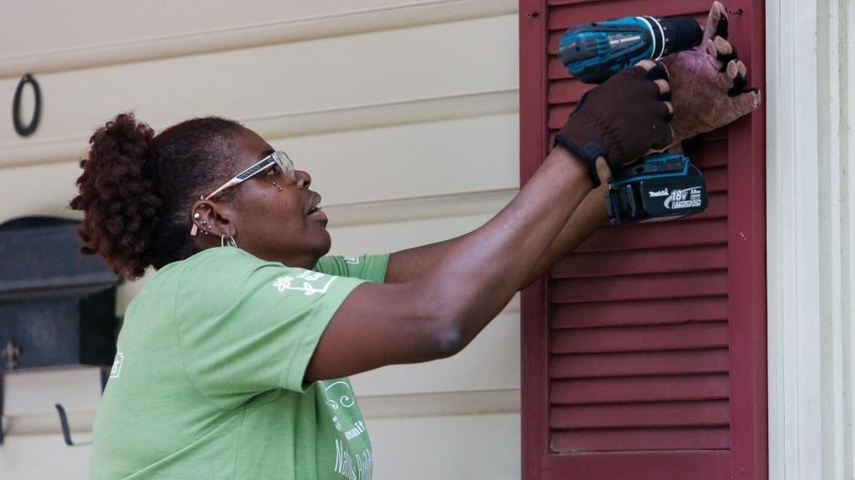 Gerri Lewis removes shutters before cleaning the house as the Habitat for Humanity National Women Build Week 2016 worked in Fort Mill’s Paradise neighborhood last year. Habitat officials are concerned about proposed cuts in the next federal budget that could impact local housing initiatives.
