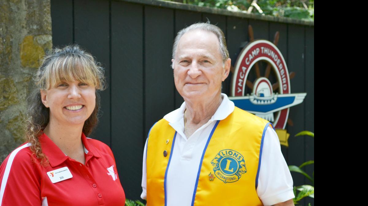 
River Hills/Lake Wylie Lions Club president Len Fleet presents a check for $200 to Jill Moore, executive director for Camp Thunderbird in Lake Wylie.
