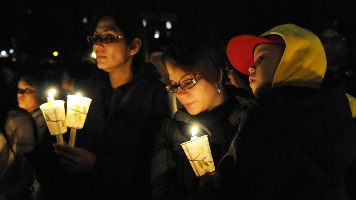 Virgin Rodriguez, second from right, holds her son, Elias, 5, during a candlelight vigil at Hartford, Connecticut's Bushnell Park on Friday, December 14, 2012, to honor the students and teachers who died at Sandy Hook Elementary School in nearby Newtown earlier in the day.