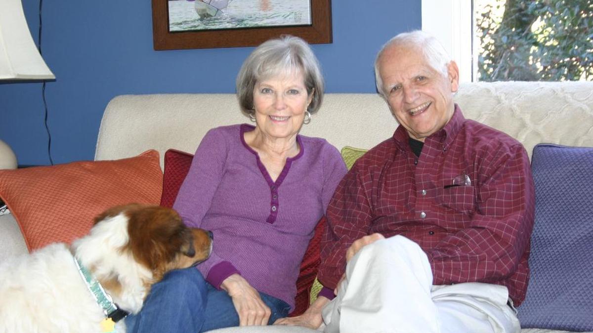 Richard “Dick” and Marg Barnes and their dog, Sparty, at their home in River Hills. Dick recently published his eighth book, “Enemies.”
