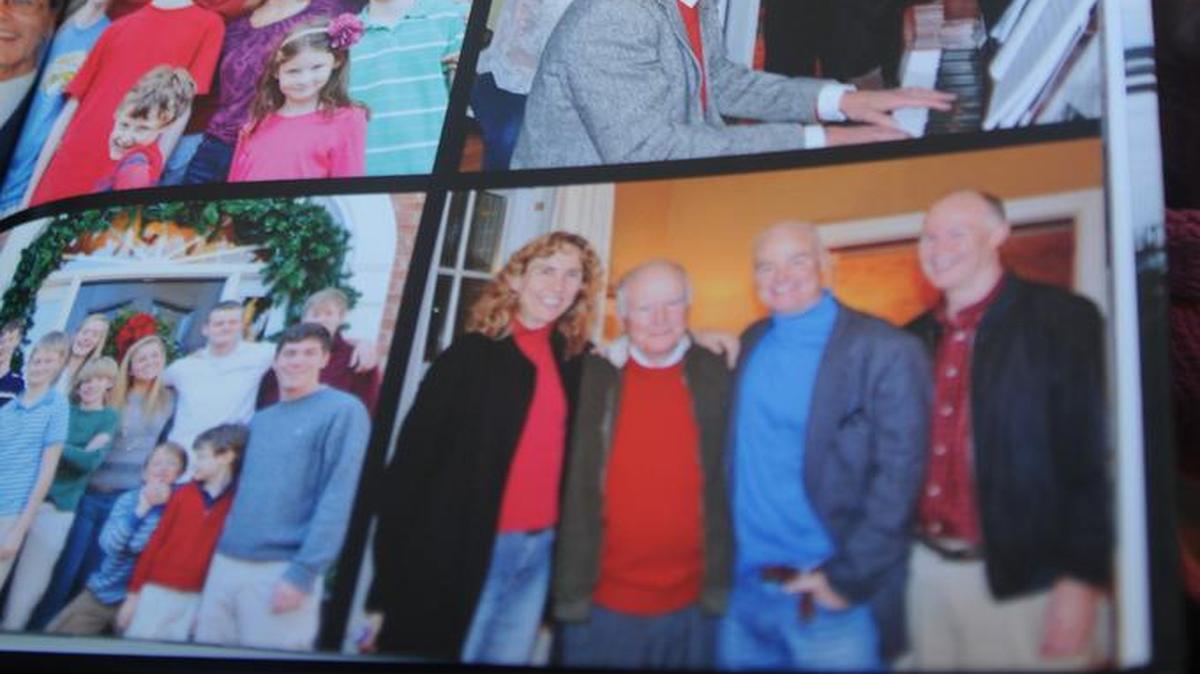 Susan Watson of Lake Wylie looks through family pictures including one, at bottom right, of Charlotte mayor-elect Jennifer Roberts with father Randy Watson and brothers William and Bruce.