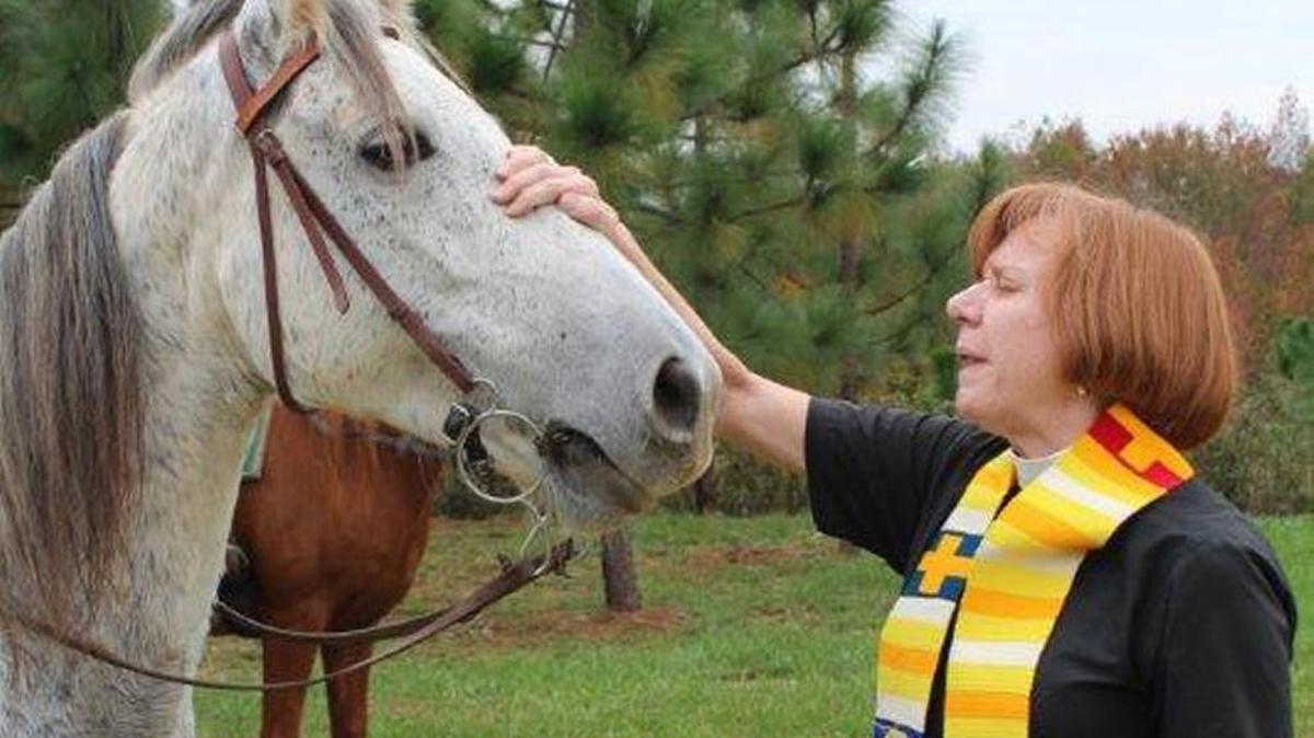 The Rev. Sally Franklin blesses a horse during St. Paul’s annual Blessing of the Animals.