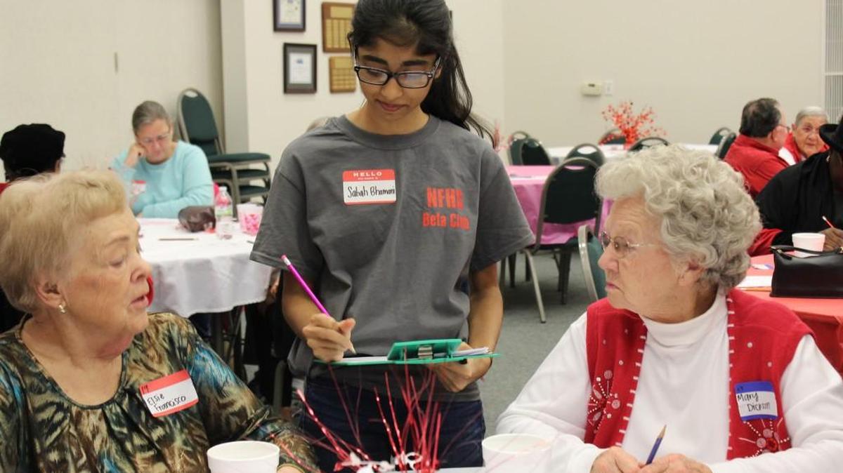 Beta Club volunteer Sabah Bhamani, middle, makes sure Elsie Francisco, left, and Mary Dickson are having a good time at the Woman’s Club of Fort Mill Valentine’s Day party for local seniors.