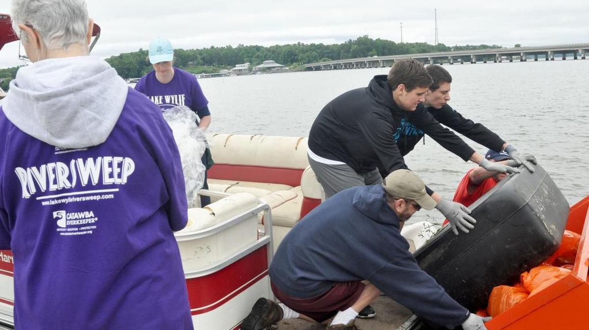 Boaters haul in a load of trash May 21 at Buster Boyd Access Area during the 14th annual Riversweep on Lake Wylie.