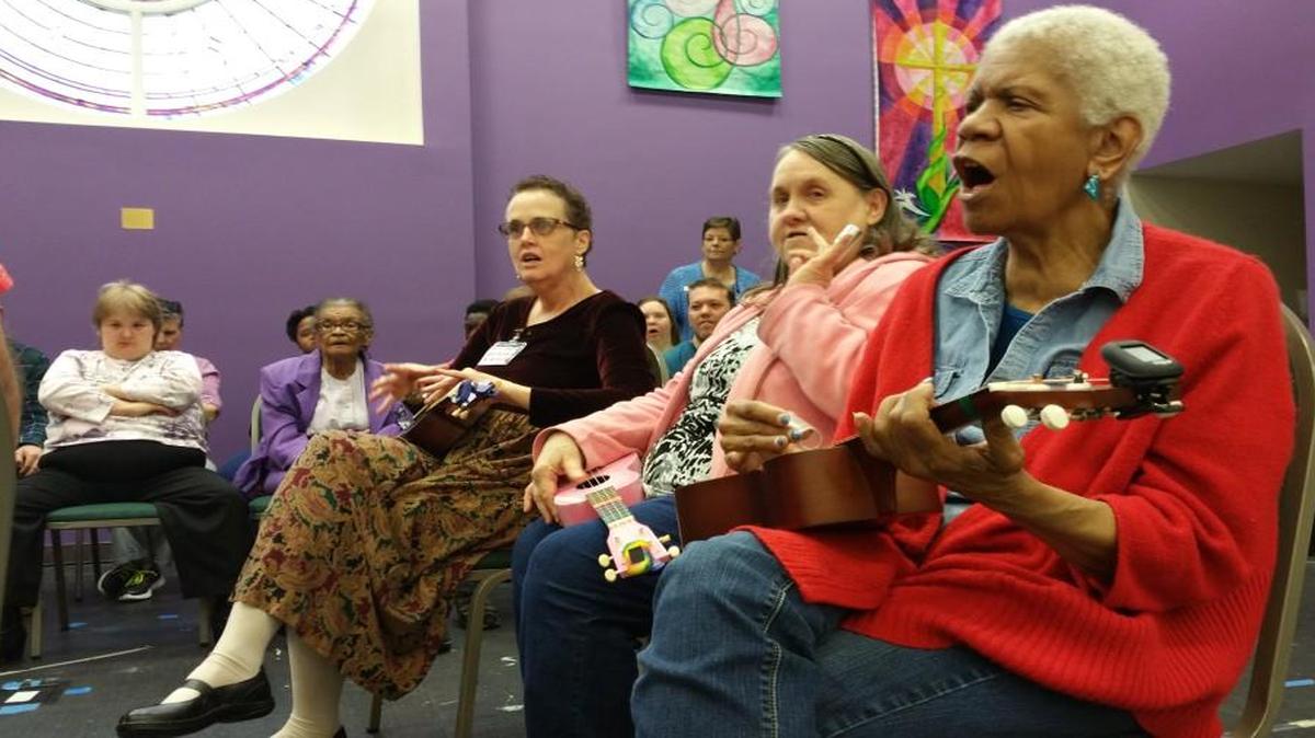 Clients at Fort Mill Adult Enrichment Center perform during the facility’s annual holiday luncheon.