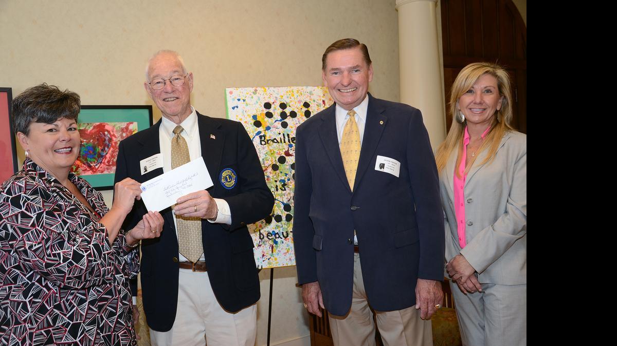 
River Hills/Lake Wylie Lions present $3,000 to South Carolina School for the Deaf and Blind. From left are Interim President  Page McCraw with Lions Lee Rowley and Lee Kehler and CEO of the Walker Foundation Ann Akerman.
