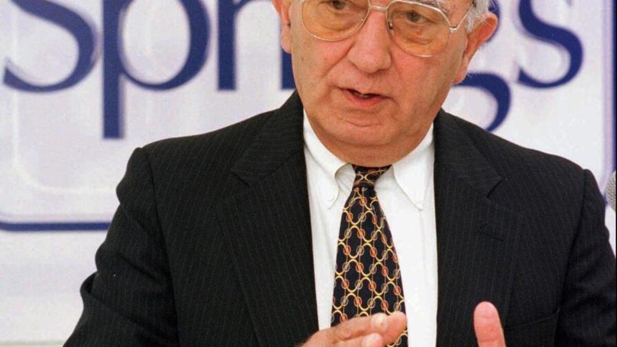 Walter Y. Elisha, former Springs Industries Inc. chairman and chief executive officer talks to the media at the Springs Annual Meeting in Fort Mill in 1997. Elisha, whose name in the town’s most iconic park, died July 4.